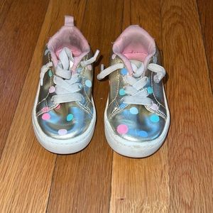 Gold sneakers with polka dots and sparkly back.